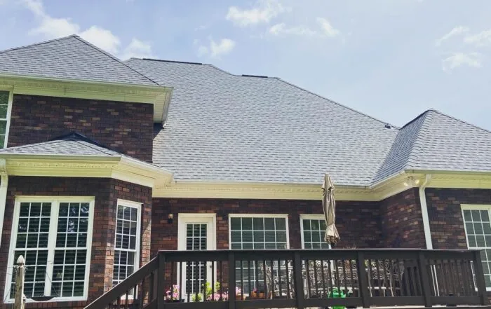 Finished shingle roof over a rear deck and brick exterior